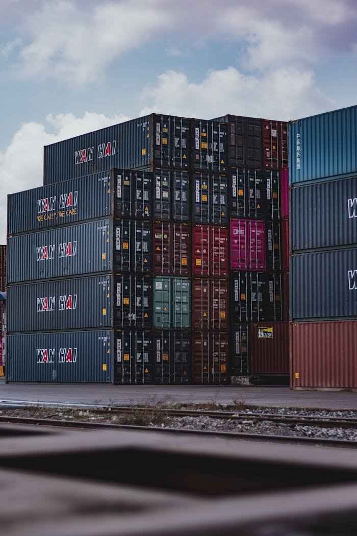 about-us-01 High vertical stack of cargo containers at a port, symbolizing global logistics.